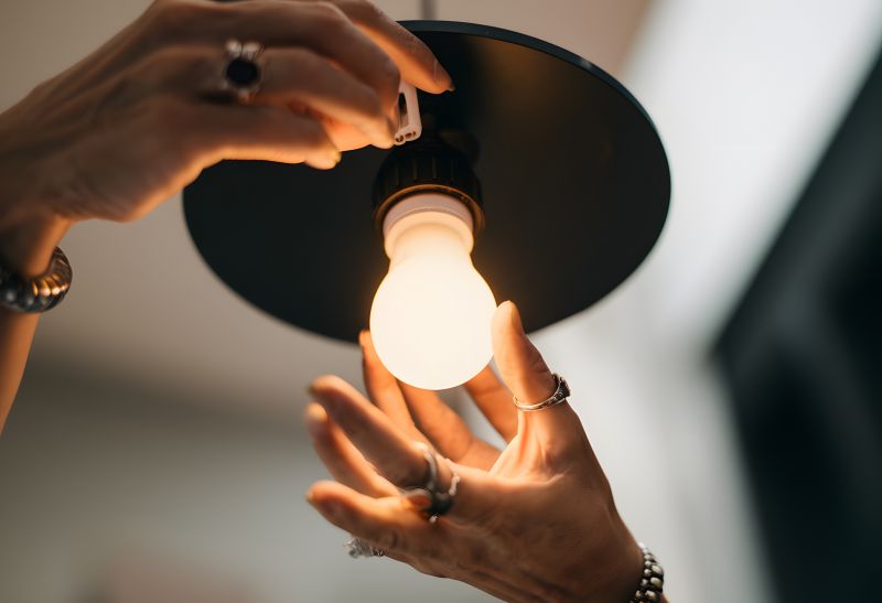 Handyman fixing a ceiling light